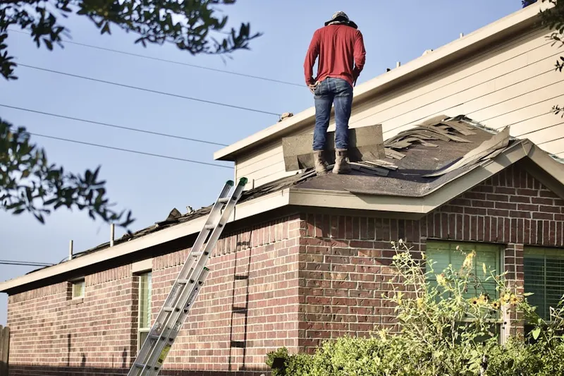 Professional roofer working on a residential roof in Creesville
